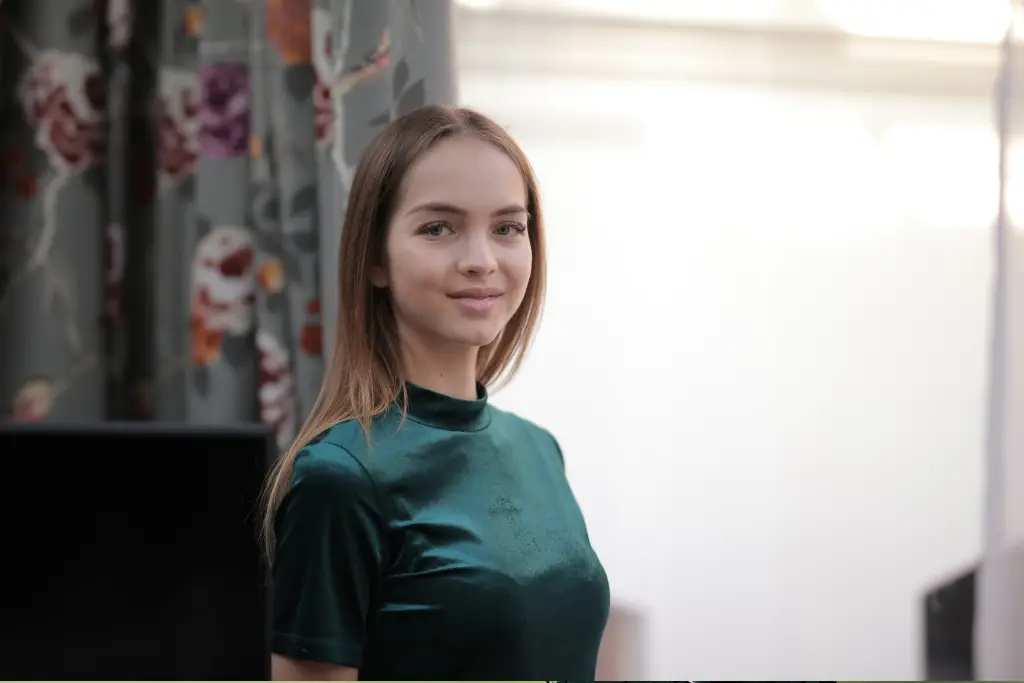 young girl wearing dark green