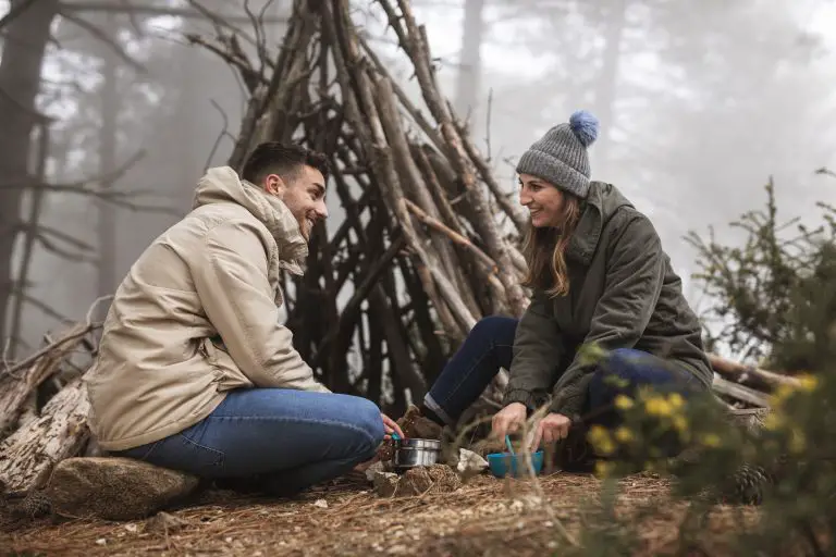 low-angle-people-with-branches-shelter
